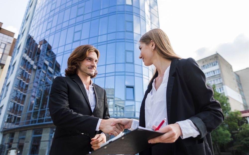 A commercial real estate agent is closing a deal with his client.