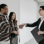 A Female Realtor Shaking Hands with Client