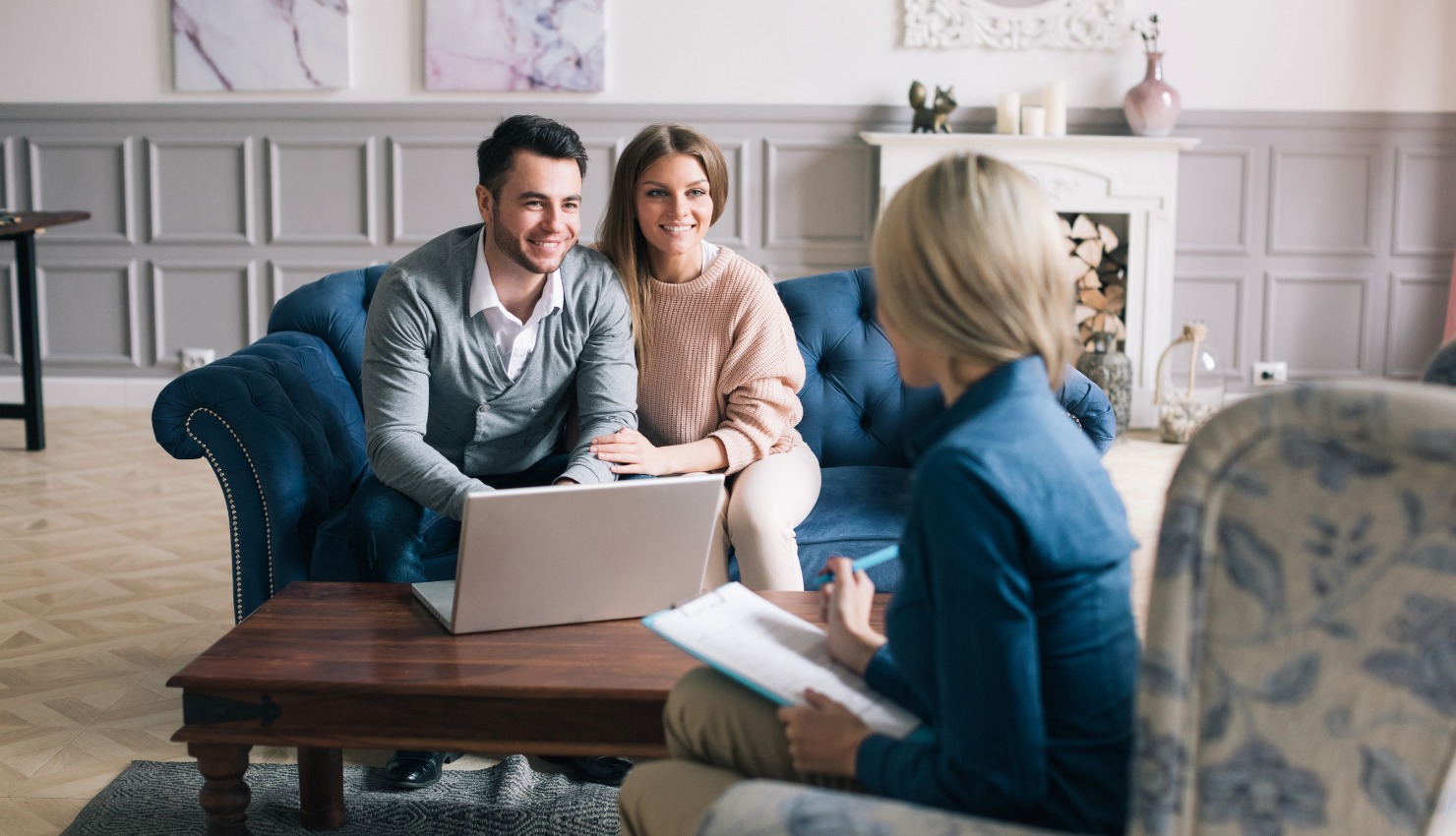 speaking with a residential real estate agent holding a clipboard
