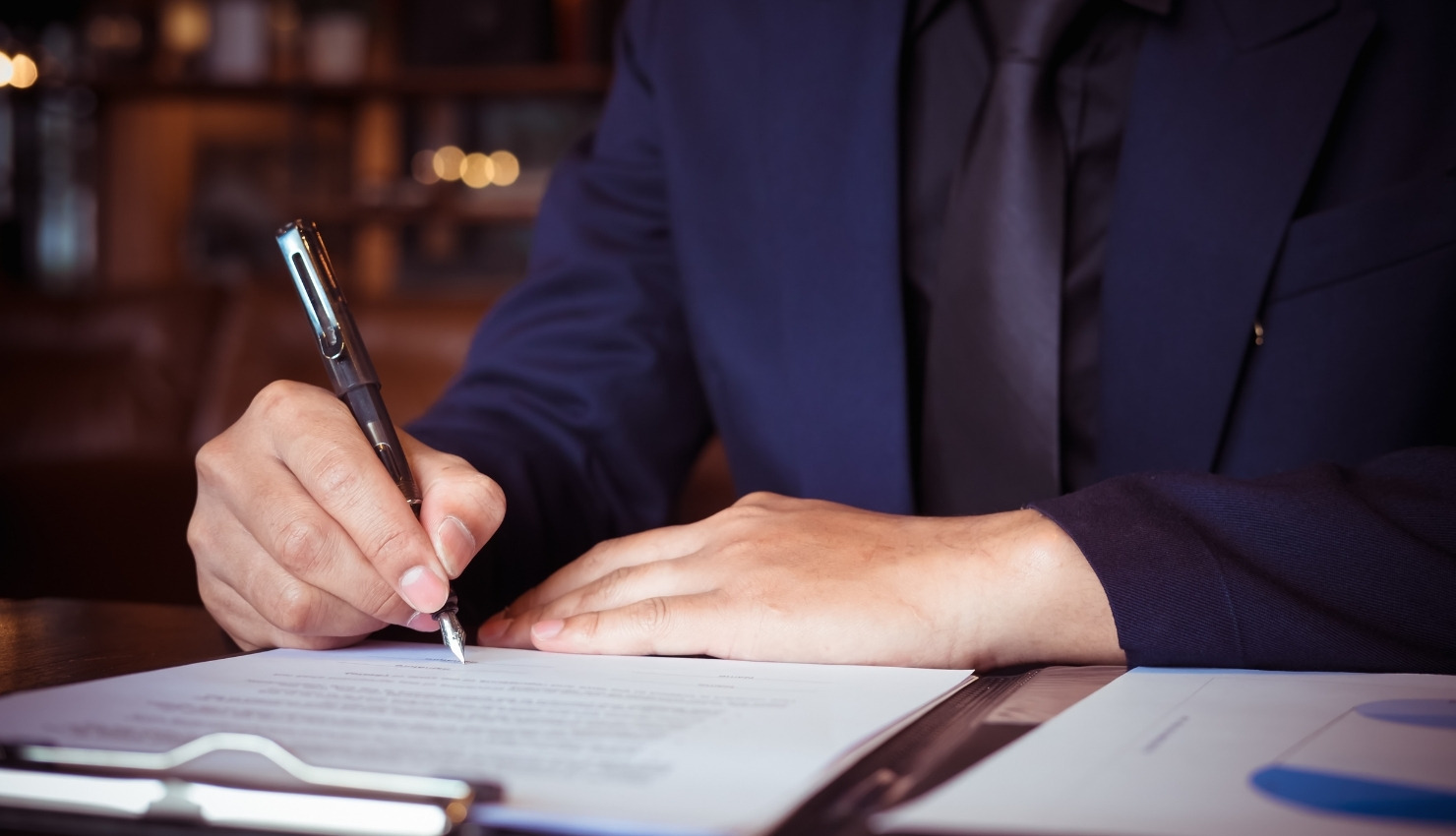 using a fountain pen to sign a contract