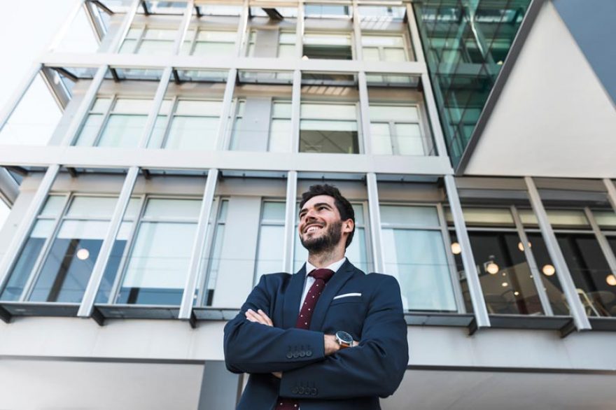 low-angle-smiley-lawyer-with-crossed-arms